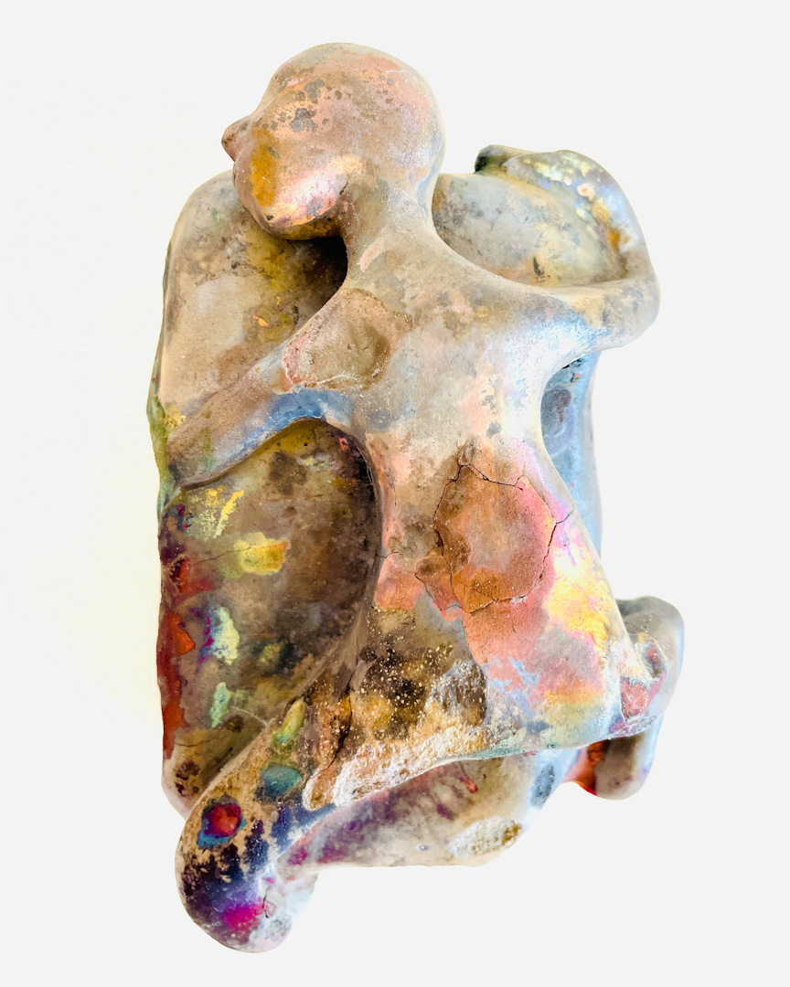 A colorful ceramic object depicting a slightly damaged, human-like character.