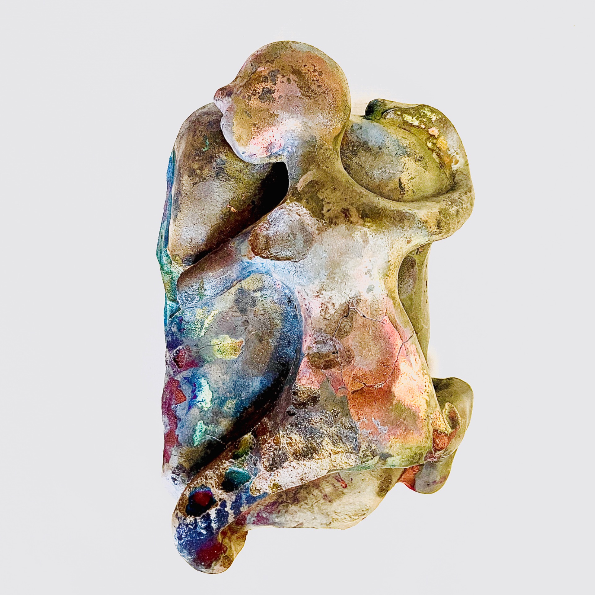 A colorful ceramic object depicting a slightly damaged, human-like character.